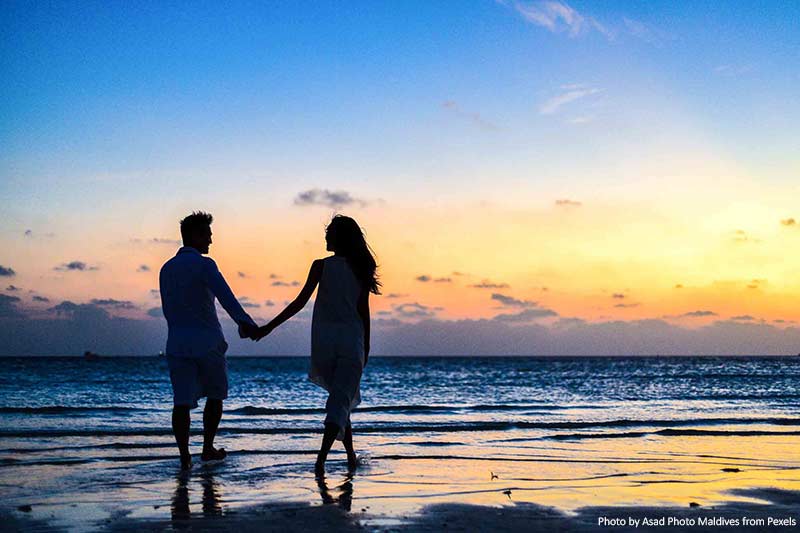 Couple Holding Hands On A Beach